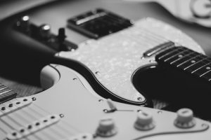 black-and-white-photo-of-two-stratocaster-electric by .