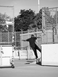 grayscale-photography-of-man-standing-beside-fence by .