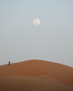 man-standing-on-desert-under-full-moon by .