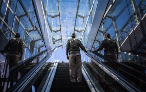 man-standing-on-escalator-during-daytime by .