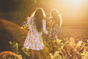 two-women-running-around-woods by .